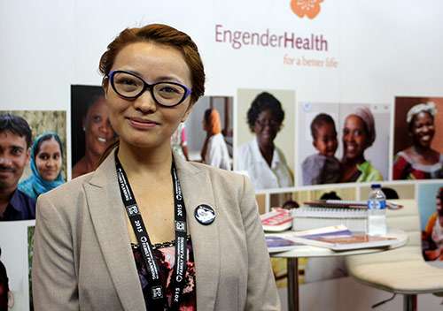 Young woman in glasses at a conference stall