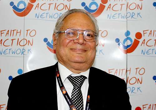 Close up of man in front of Action Network poster